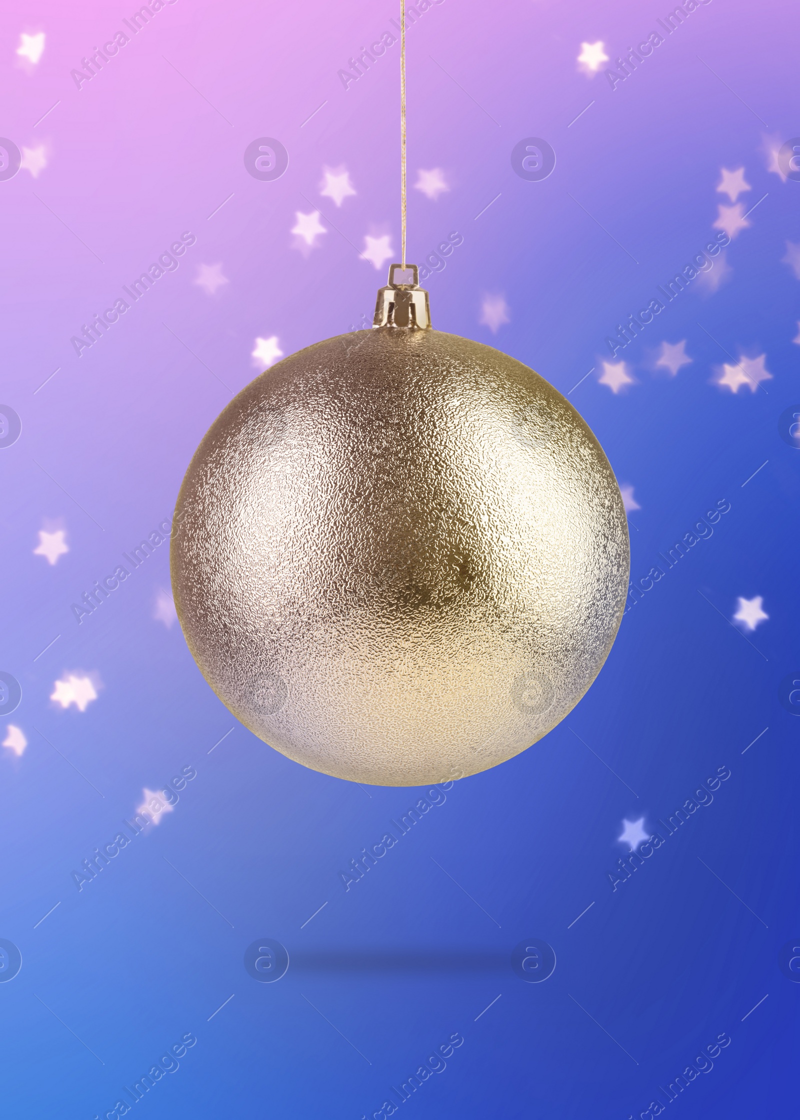 Image of Beautiful golden Christmas ball hanging on color background