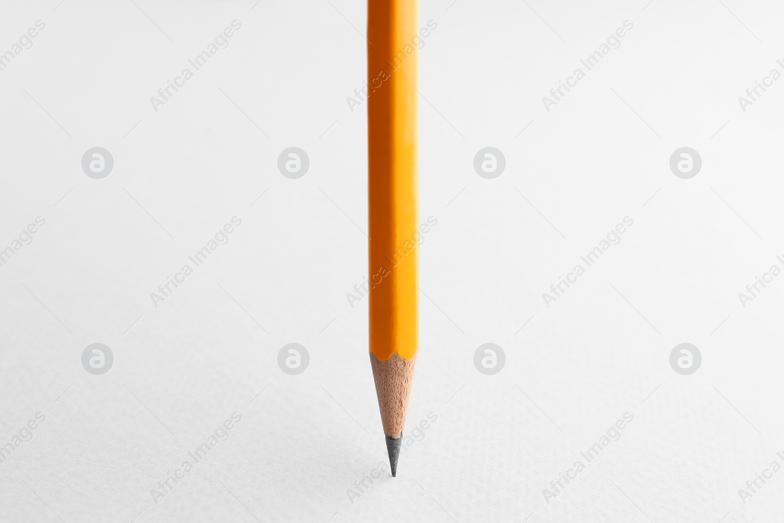 Photo of One sharp graphite pencil on white background, closeup. Space for text