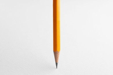 Photo of One sharp graphite pencil on white background, closeup. Space for text