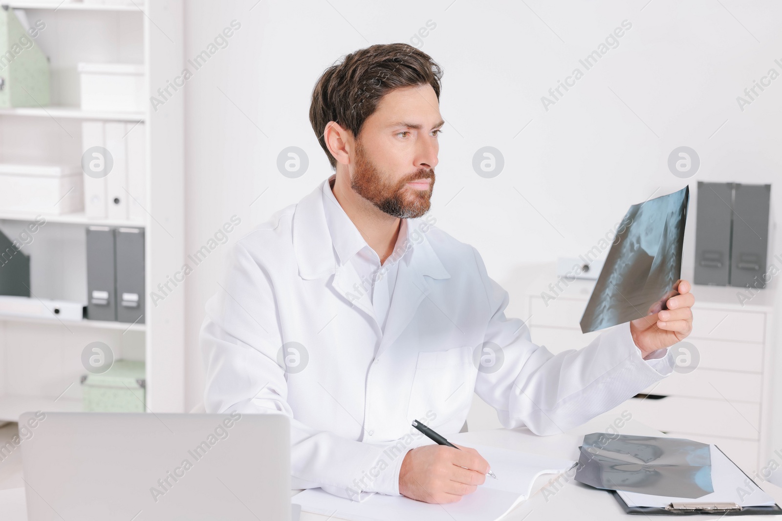 Photo of Doctor writing results from MRI scan in hospital