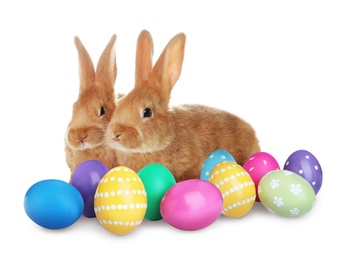 Image of Cute bunnies and wicker basket with bright Easter eggs on white background