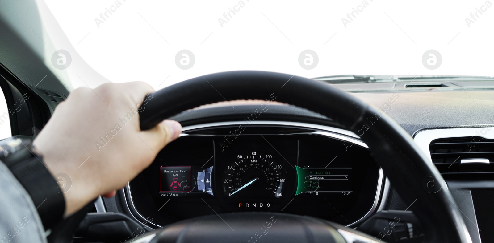 Photo of Man driving car with speedometer on dashboard, closeup