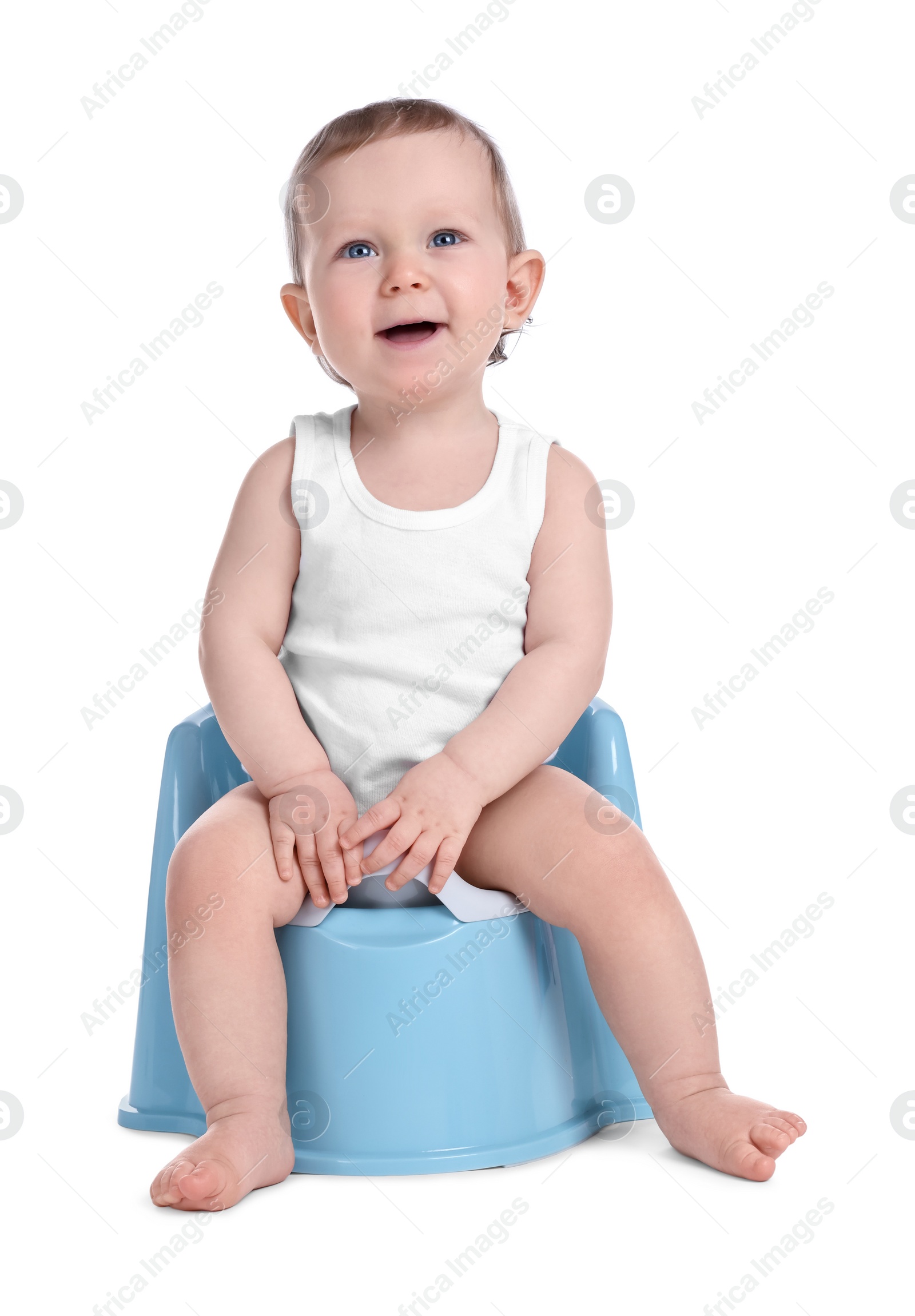 Photo of Little child sitting on baby potty against white background