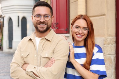 Portrait of happy couple in glasses outdoors