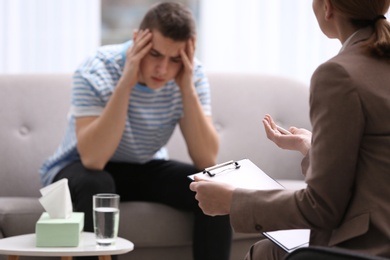 Psychotherapist working with young man in office