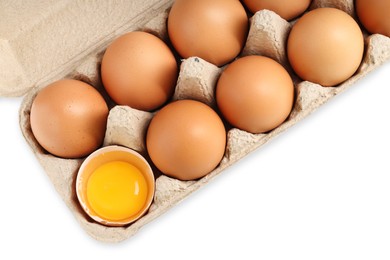 Photo of Chicken eggs in carton isolated on white, top view