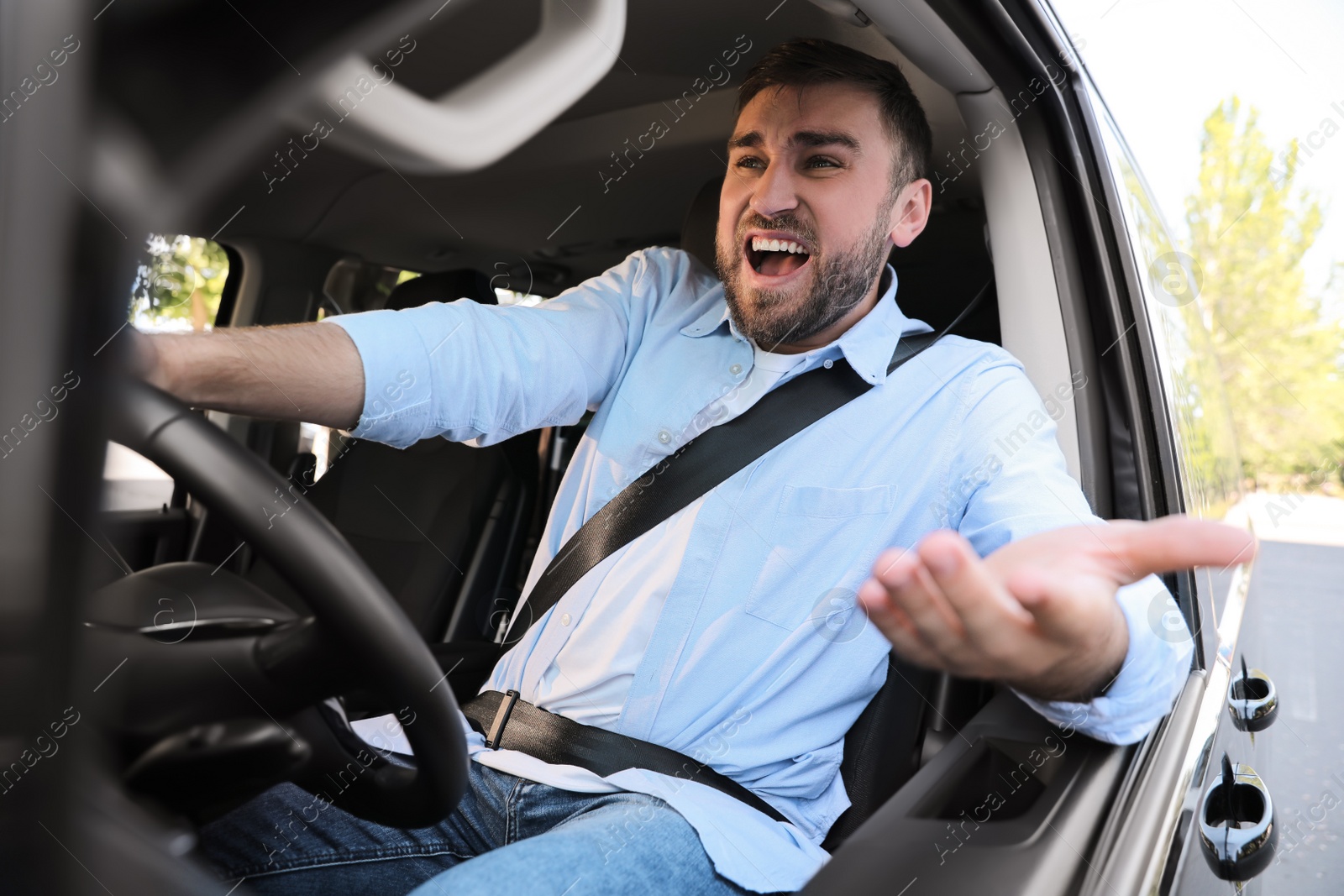 Photo of Emotional man in car. Aggressive driving behavior