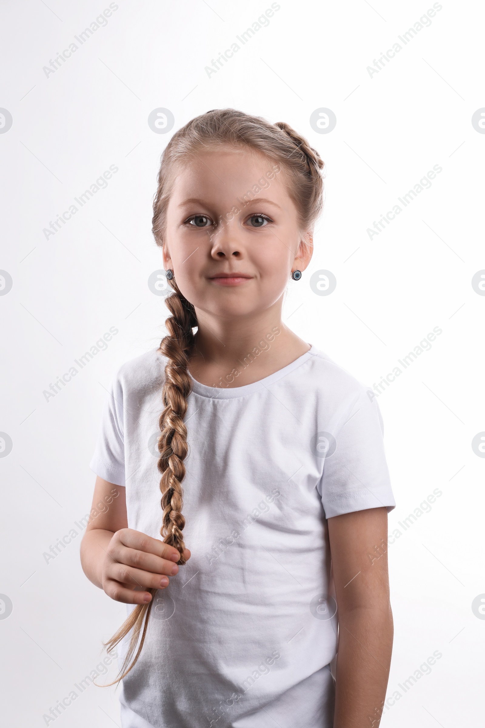 Photo of Little girl with braided hair on white background