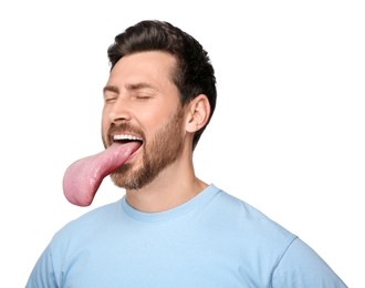 Portrait of handsome man showing long tongue on white background