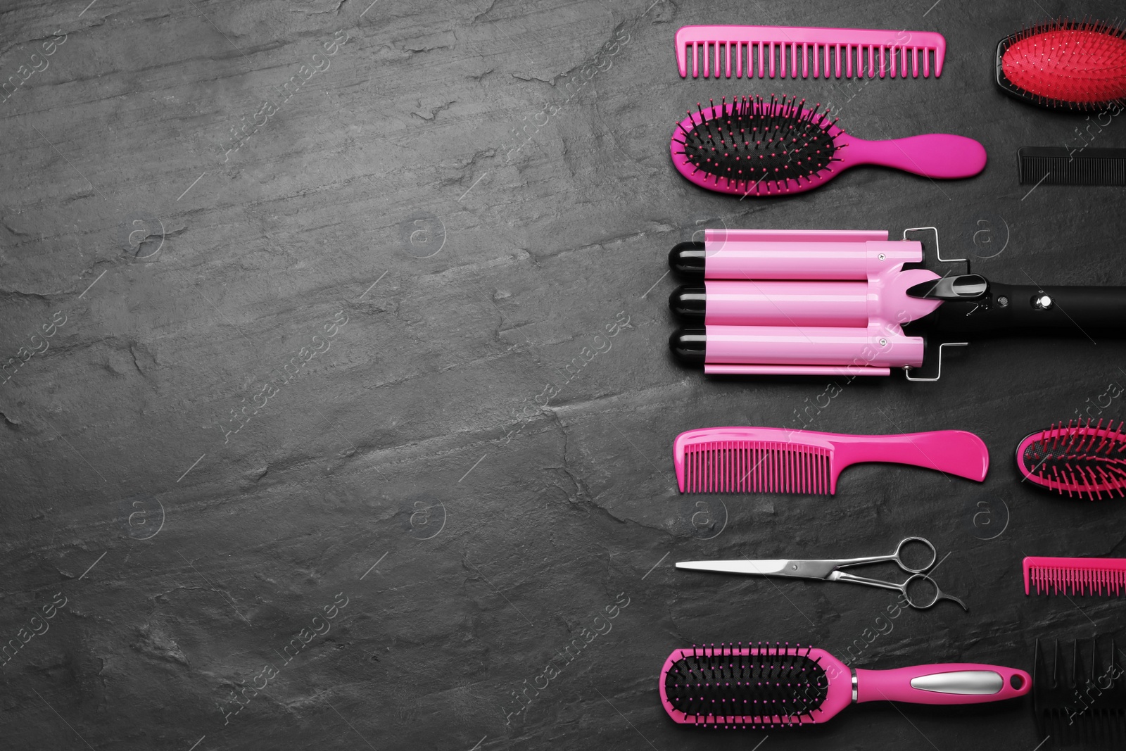 Photo of Flat lay composition of professional hairdresser tools on dark grey table, space for text