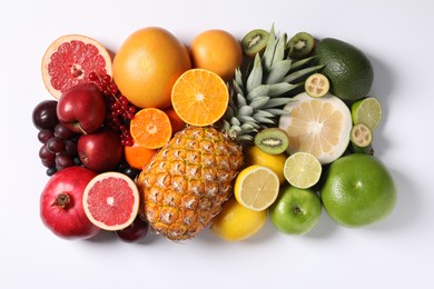 Photo of Different ripe fruits and berries on white background, top view
