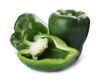 Whole and cut green bell peppers isolated on white