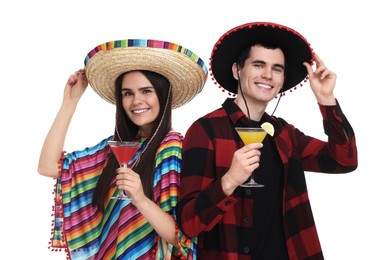 Photo of Lovely couple in Mexican sombrero hats with cocktails on white background