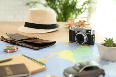 Composition with vintage camera and different items on table. Trip planning