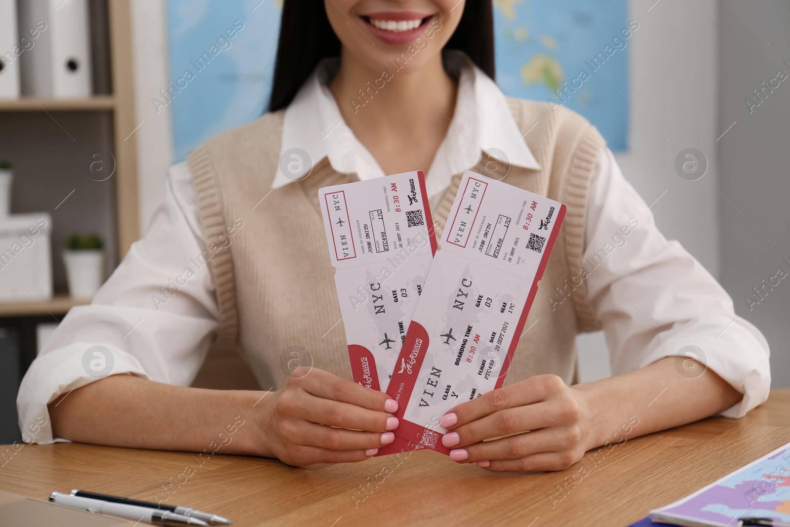 Photo of Travel agent with tickets at table in office, closeup