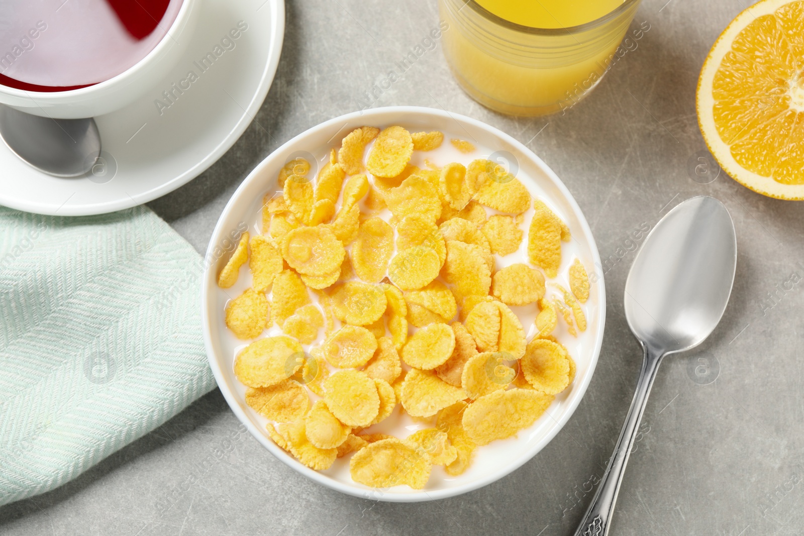 Photo of Flat lay composition with tasty corn flakes on light grey table