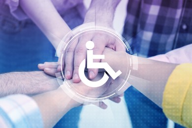 Inclusion concept. International symbol of access. People holding hands together, closeup