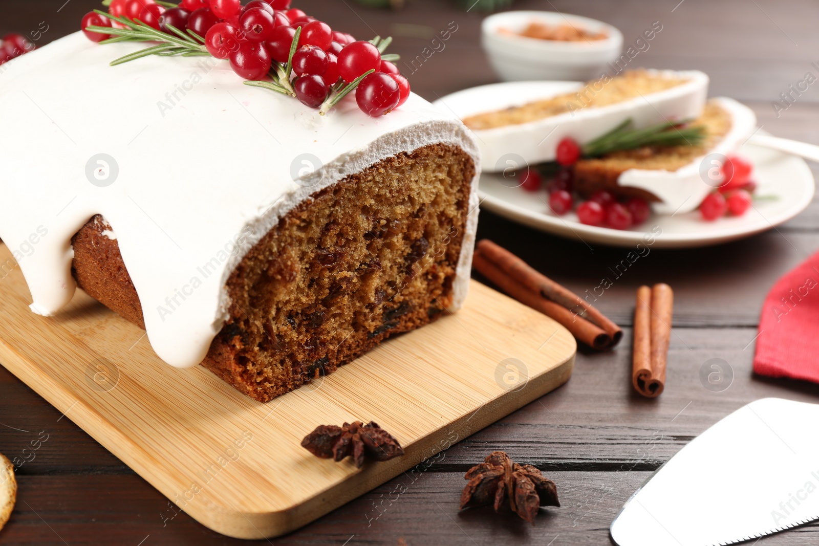 Photo of Traditional classic Christmas cake decorated with cranberries on wooden table