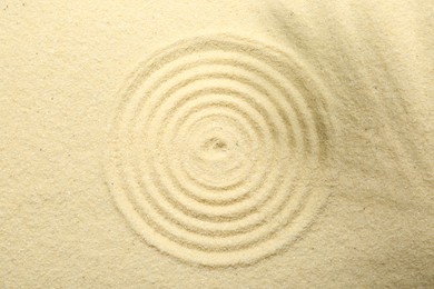 Zen rock garden. Circle pattern on beige sand, top view