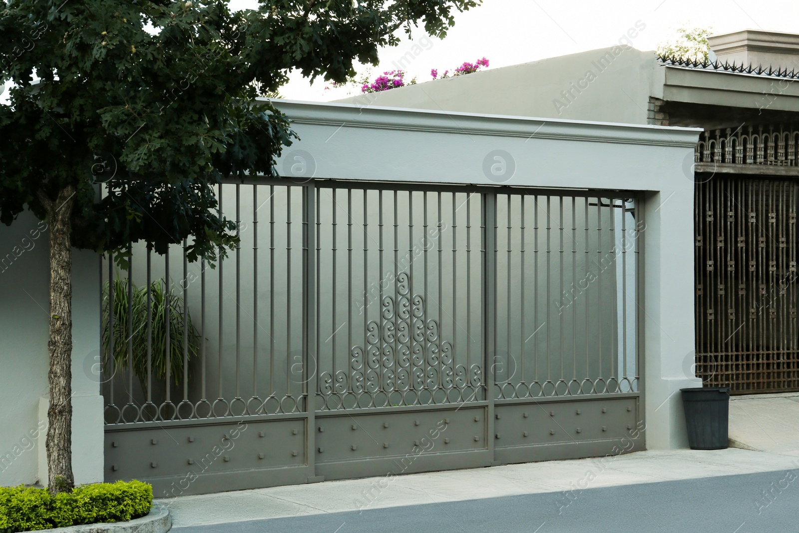 Photo of Beautiful closed metal gate and fence outdoors