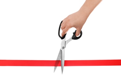 Photo of Woman cutting red ribbon with scissors on white background. Traditional ceremony