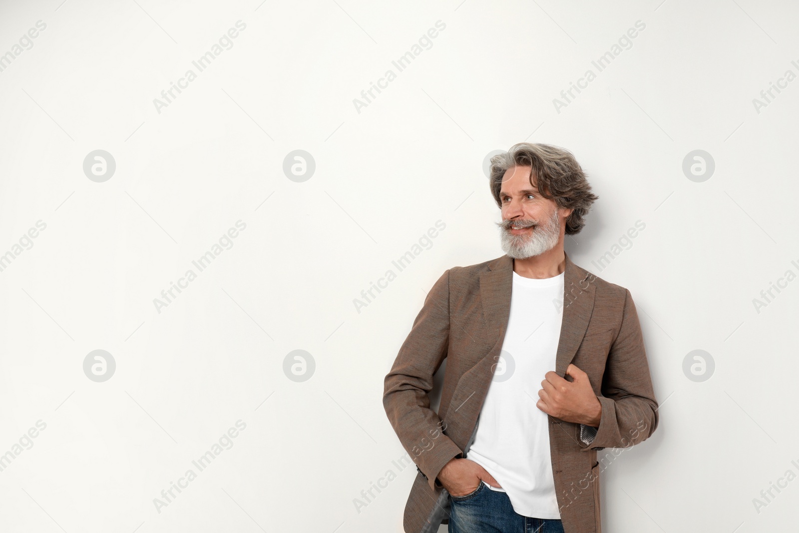 Photo of Portrait of handsome mature man on light background. Space for text