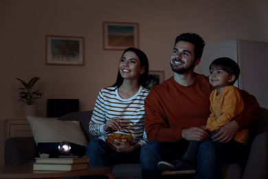 Photo of Family watching movie using video projector at home