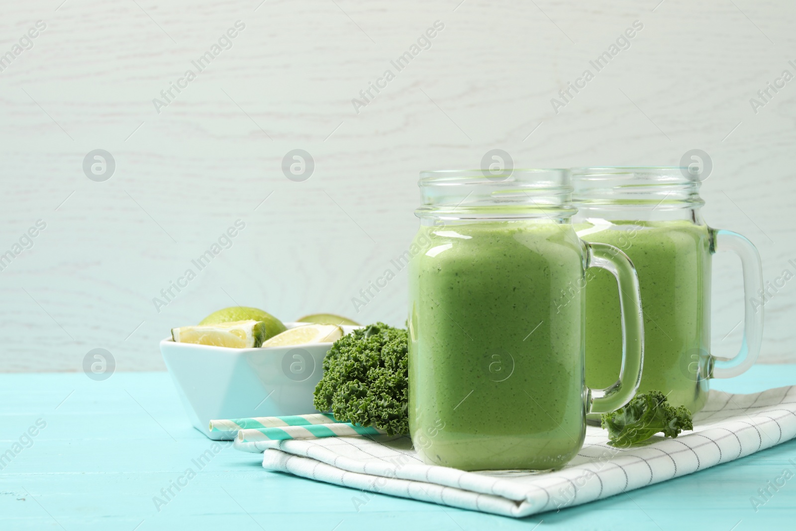 Photo of Tasty fresh kale smoothie on light blue wooden table