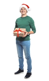 Photo of Young man with Christmas gift on white background