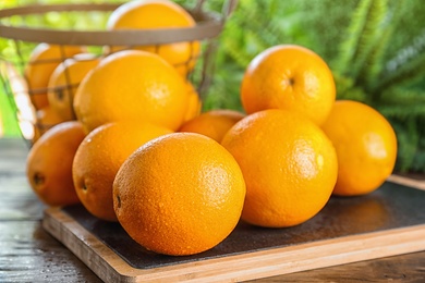 Fresh juicy oranges on wooden table. Healthy fruits