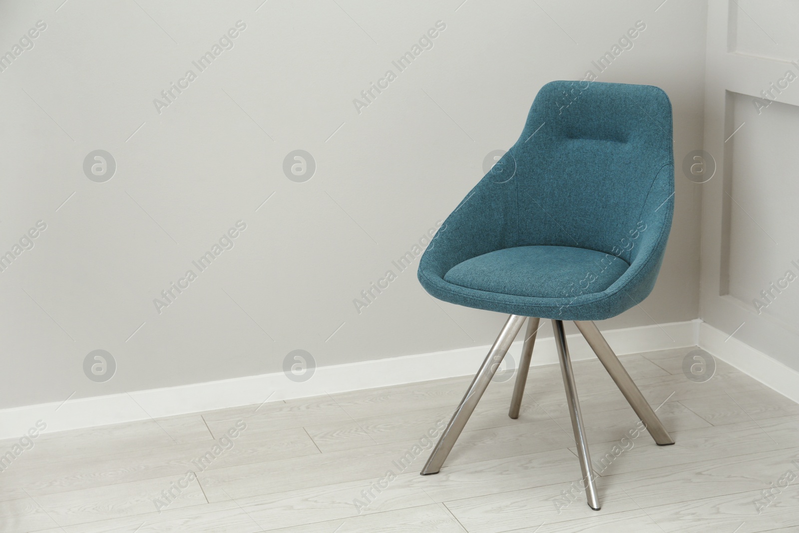 Photo of Stylish chair near light wall in room. Space for text