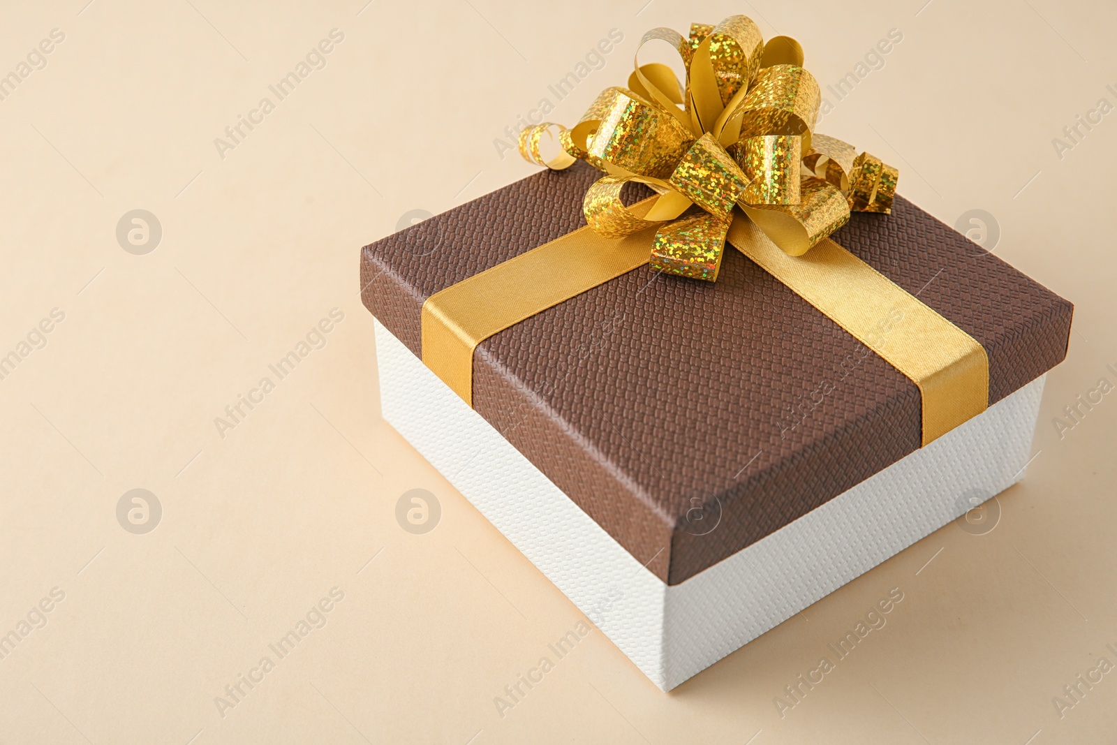 Photo of Beautiful gift box with bow on beige background