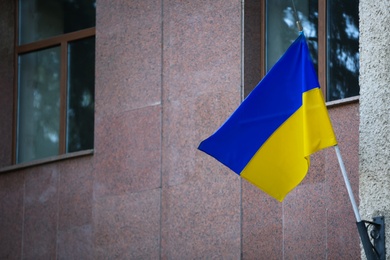 Photo of National flag of Ukraine on building wall outdoors