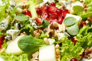 Photo of Delicious fresh salad with pear as background, closeup view
