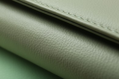 Photo of Green leather with seam on table, closeup