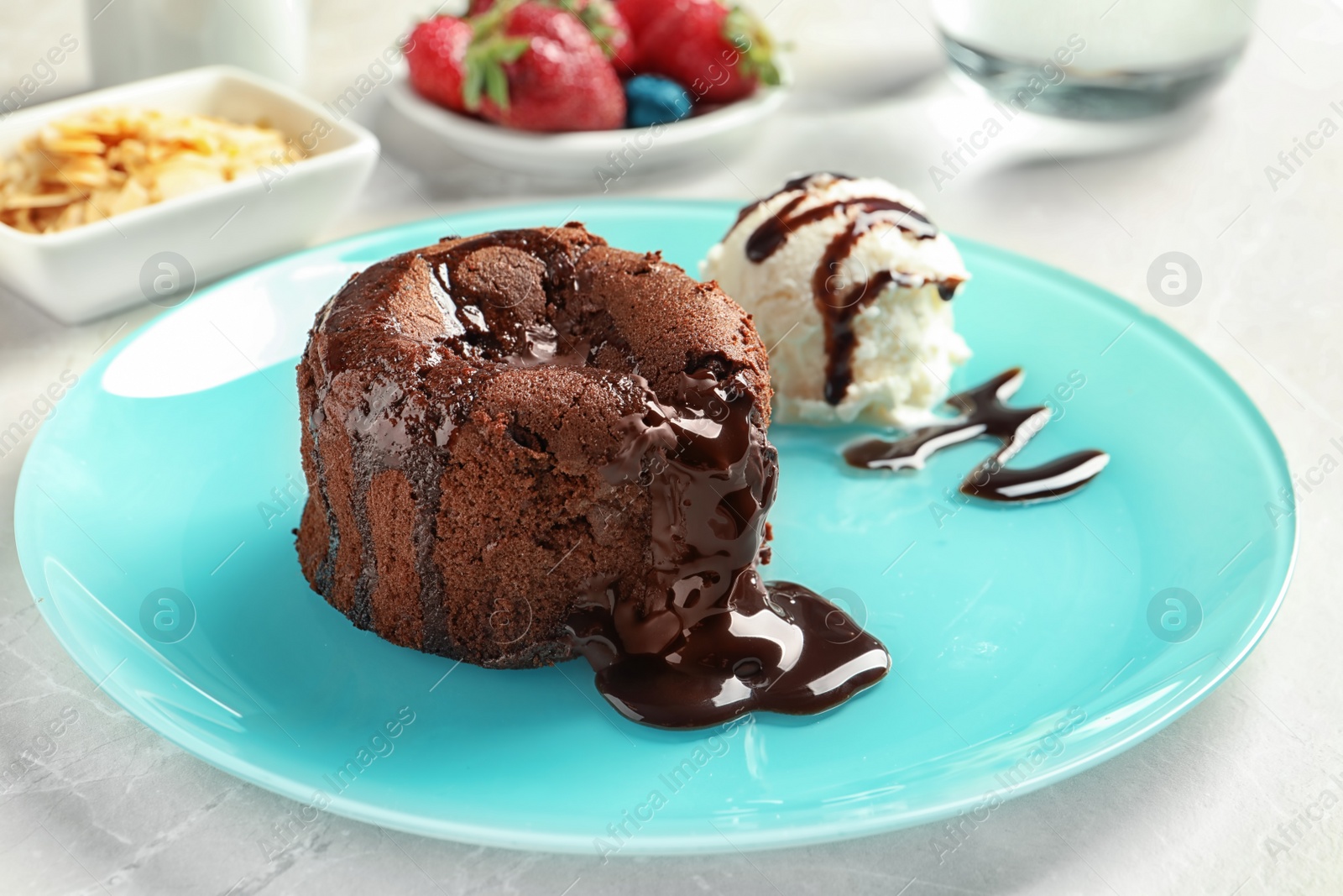 Photo of Plate of delicious fresh fondant with hot chocolate and ice cream on table. Lava cake recipe