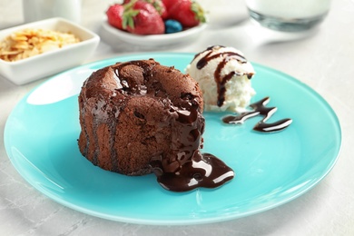 Plate of delicious fresh fondant with hot chocolate and ice cream on table. Lava cake recipe