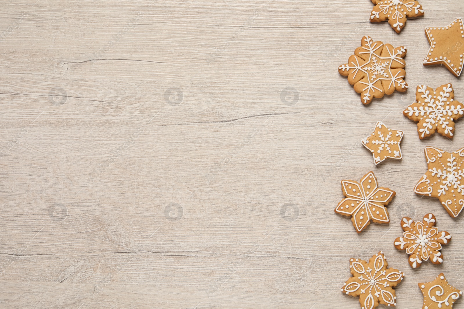Photo of Tasty Christmas cookies on beige wooden table, flat lay. Space for text