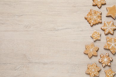 Tasty Christmas cookies on beige wooden table, flat lay. Space for text