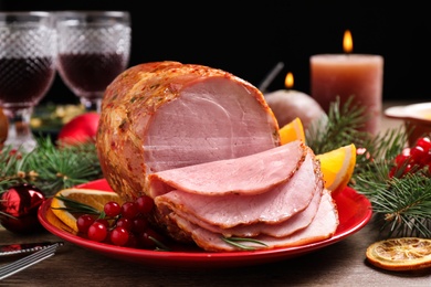 Photo of Plate with delicious ham served on wooden table. Christmas dinner