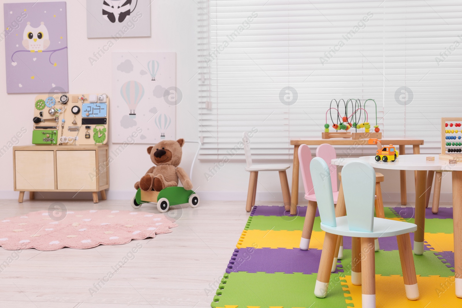 Photo of Stylish kindergarten interior with toys and modern furniture