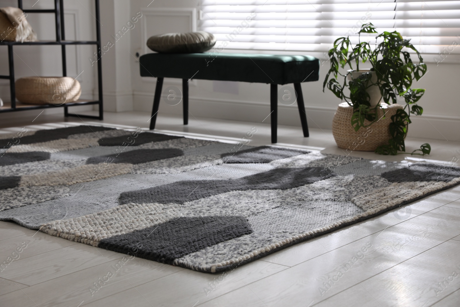 Photo of Stylish carpet with pattern on floor in room