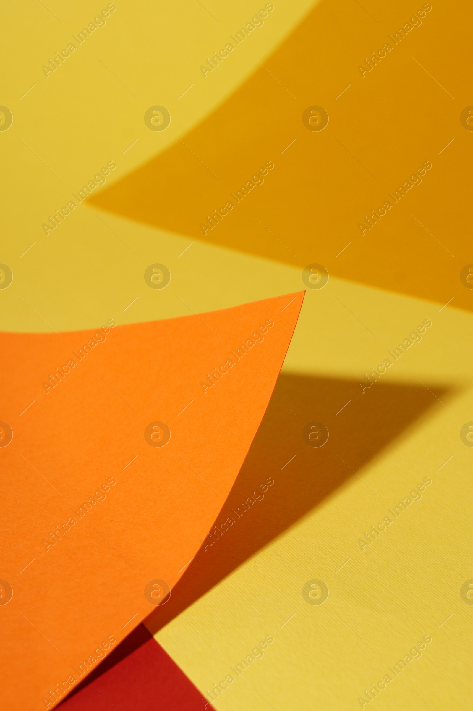 Photo of Different colorful paper sheets on yellow background