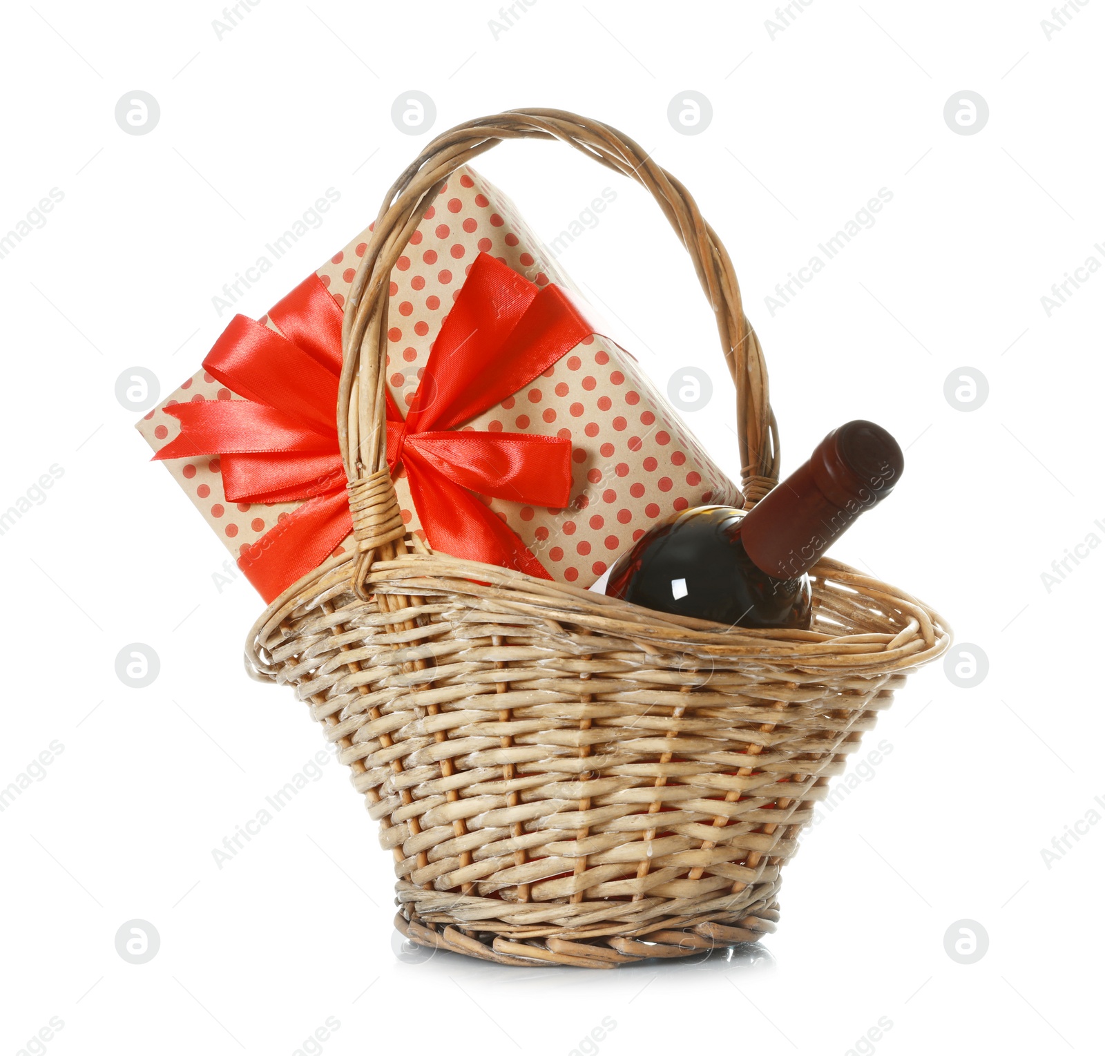 Photo of Basket with bottle of wine and gift on white background