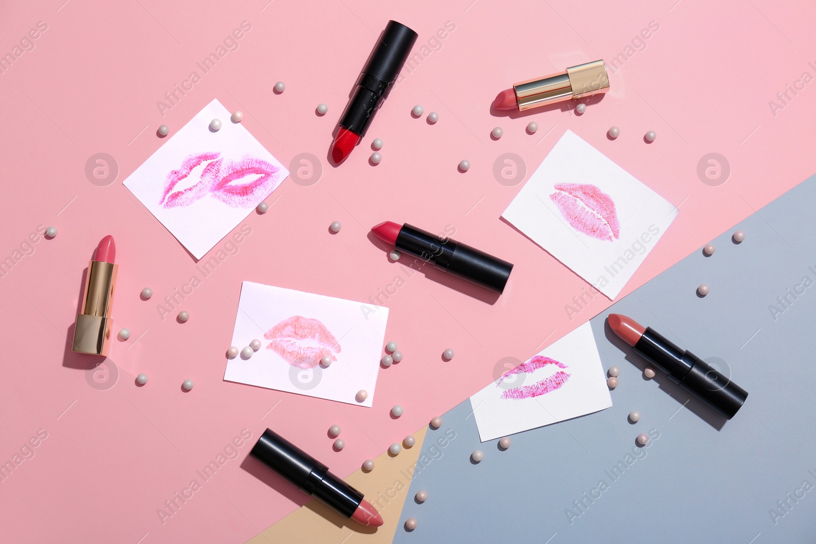 Photo of Flat lay composition with lipsticks on color background. Professional cosmetic products