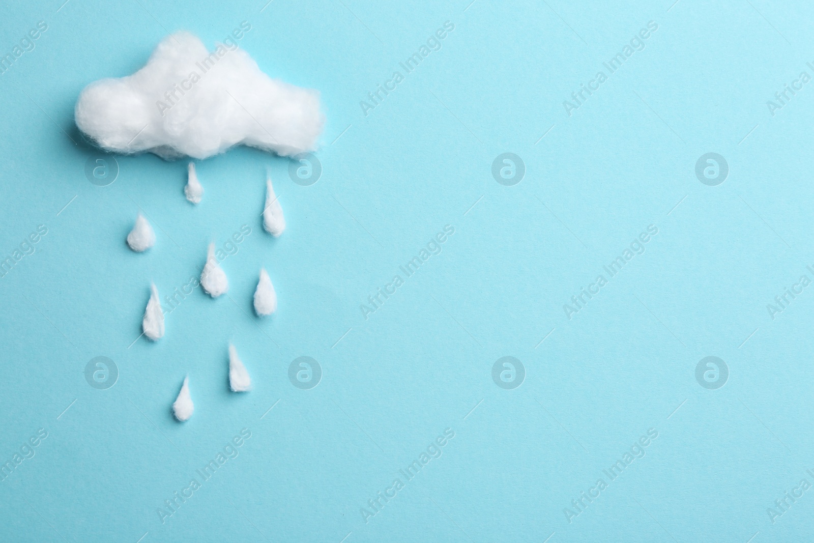 Photo of Cloud and raindrops made of cotton on blue background, flat lay. Space for text