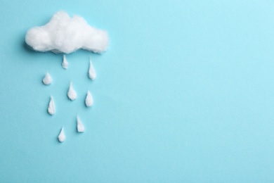 Photo of Cloud and raindrops made of cotton on blue background, flat lay. Space for text