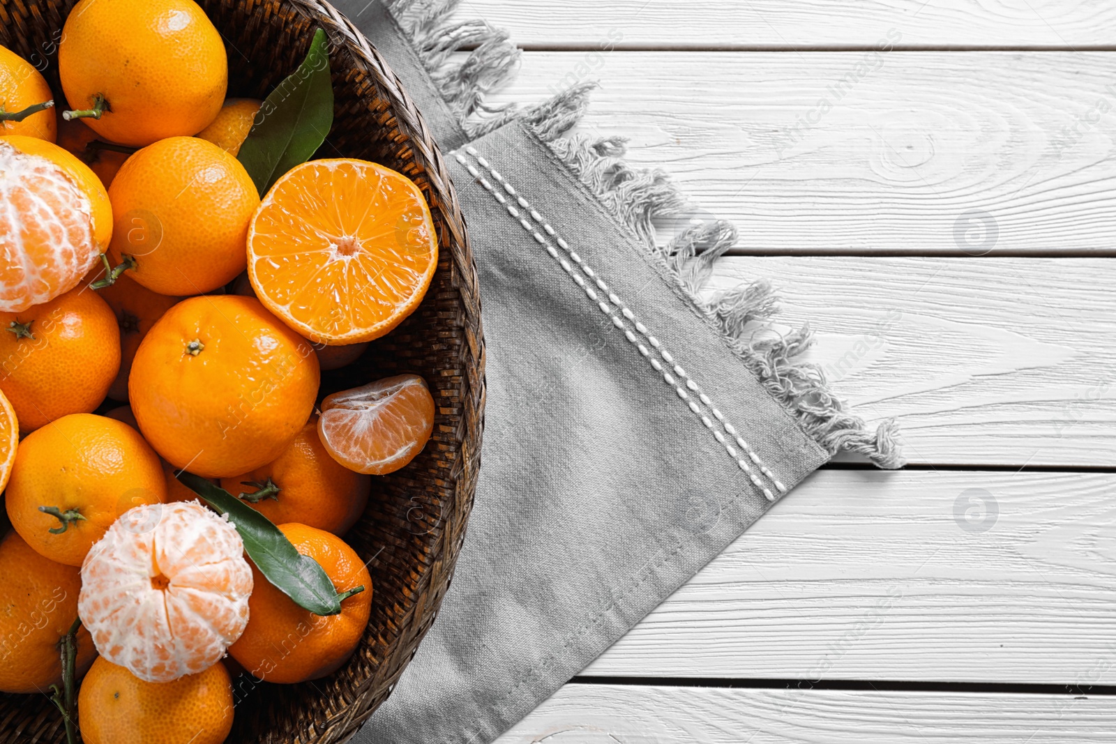 Photo of Fresh ripe tangerines on white wooden table, top view