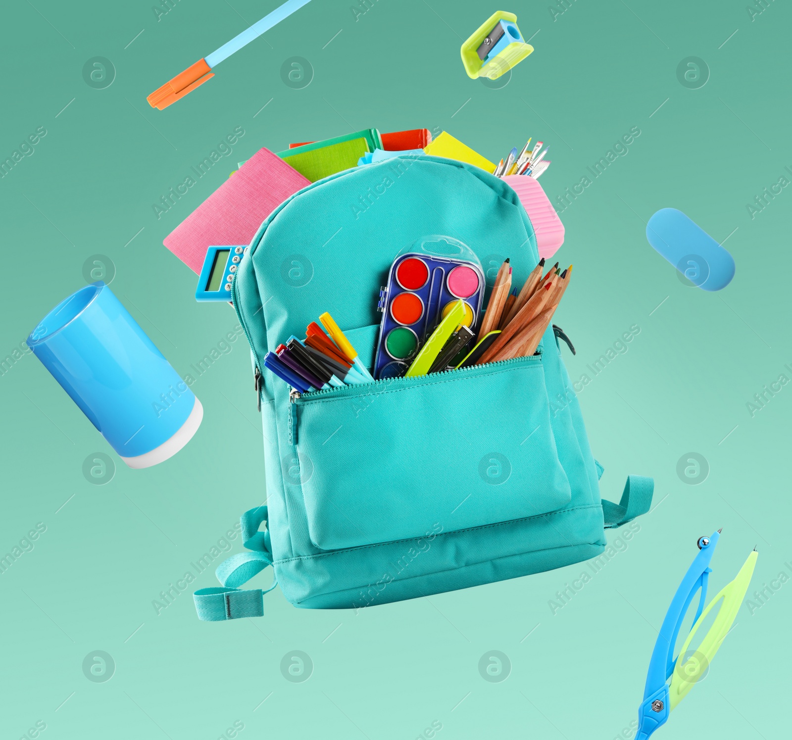 Image of Backpack surrounded by flying school stationery on pale green background