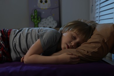 Little boy snoring while sleeping in bed at night